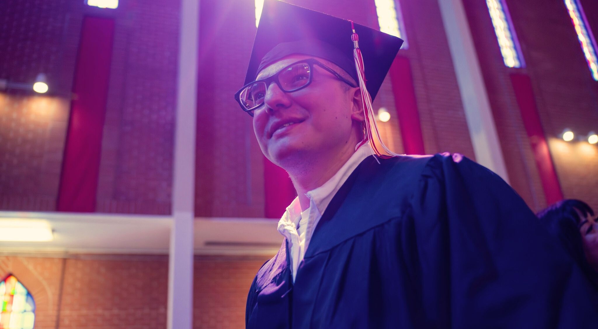 Graduate of the Lee College Huntsville Program wearing cap and gown on graduation day.